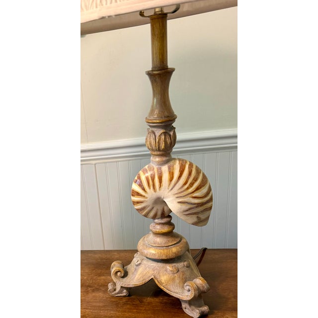 The ornate, distressed-look with an aged finish and prominent coastal/nautical theme due to the nautilus shells, these...