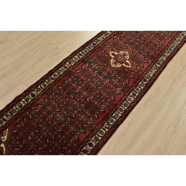 An authentic vintage tribal Hamedan runner hand-knotted with fine wool and natural dyes. This nomadic rug features a...