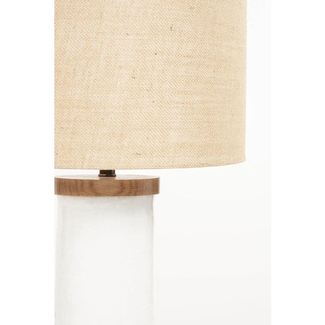 White cylinder-shape table lamp, custom-made from hand-thrown ceramic cylinder finished with wooden base and top. Newly...