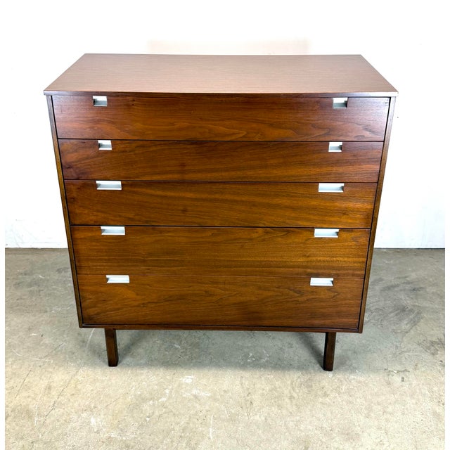 A beautiful mid century modern walnut tall dresser by Bassett Furniture circa 1960’s. Features five progressively sized...