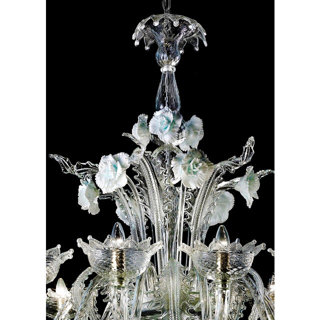 Venetian floreal Murano glass chandelier with leaves and flowers pinched by hand full of precious white details. That give...