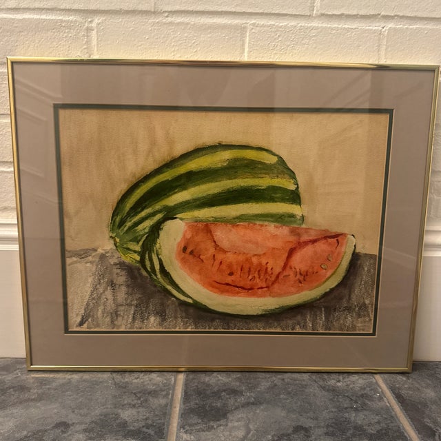 Vibrant and cheerful vintage still life print depicting a freshly cut watermelon with its vivid green stripes and juicy...