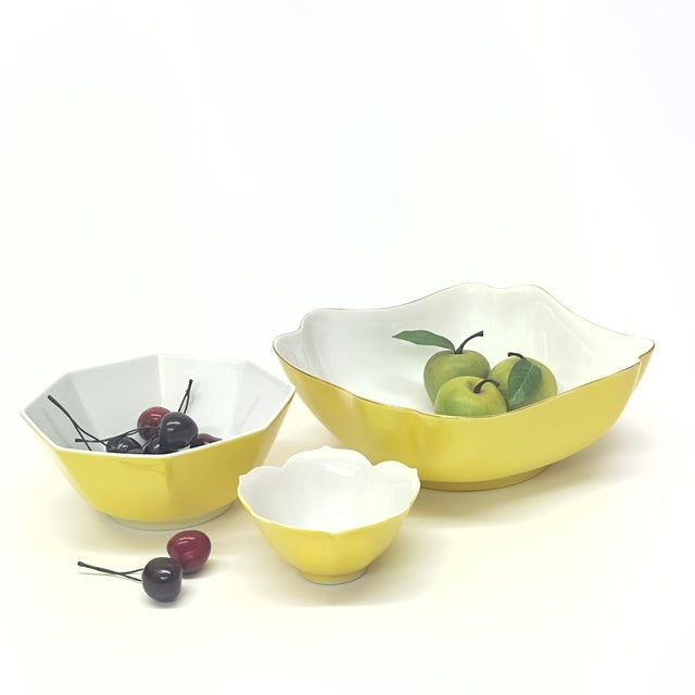 Yellow ceramic bowls, group of 3. A set of mid-20th century lemon-yellow ceramic serving bowls with white interiors,...