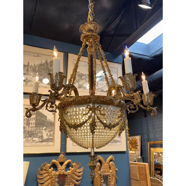 The 19th Century French Bronze and Crystal Chandelier is a luxurious and elegant lighting fixture. The combination of...