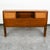 Walnut and Cane sliding door full-size headboard by BP john. Each of the 2 doors slide on tracks in front of the storage...