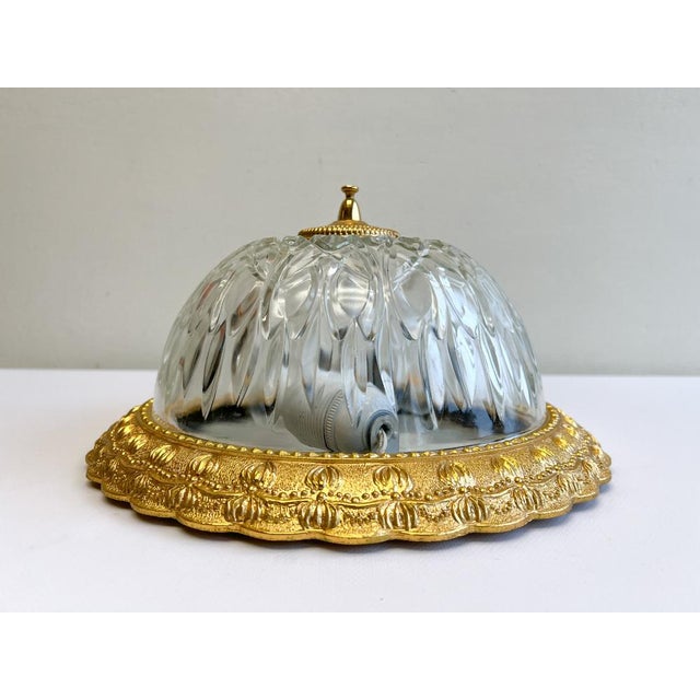 Classic beautifully detailed brass and cut glass ceiling lamp. The gold-coloured fitting is cast in a stylish motif and...