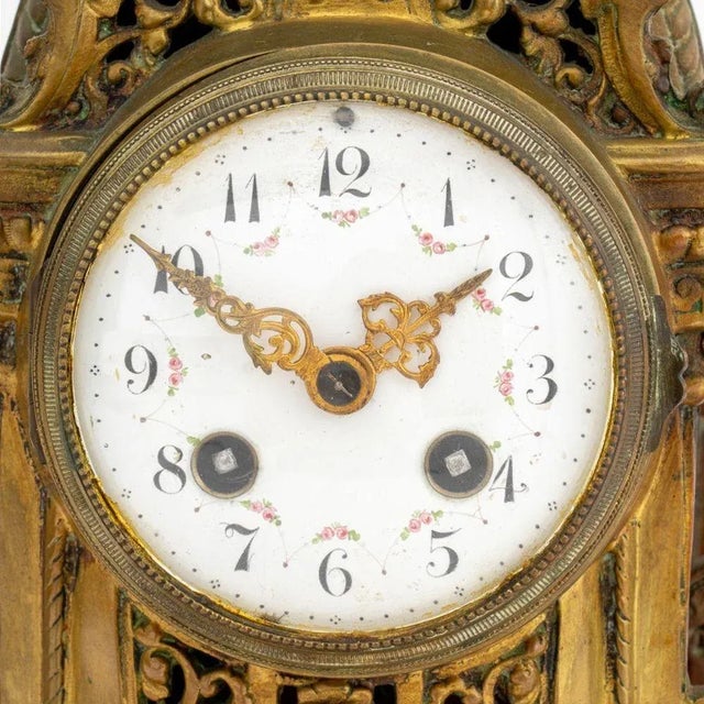 French Rococo Style Brass Mantel Clock, late 19th century, with fleur-de-lis finial, pierced scroll form body on six legs,...