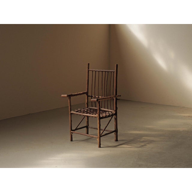 Unusual French armchair made entirely from raw hazelnut branches, dating from around 1970. The natural curves, knots, and...