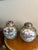 Rich in opulence and storytelling, this vintage pair of lidded urns from China presents a vivid tableau of equestrian...