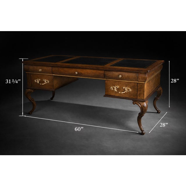 An elegant and substantial executive desk crafted in the Queen Anne tradition, featuring richly figured burl wood veneers,...