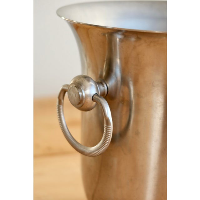 Vintage stainless steel champagne bucket by Jean Couzon, featuring a simple and elegant design, two circular side handles,...