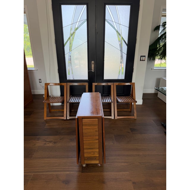 An exceptionally clever and beautifully engineered Mid-Century Modern space-saving dining set, crafted in Romania during...