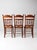 A set of three early 20th-century Eastlake Revival dining chairs blending American Country Victorian styling with carved...