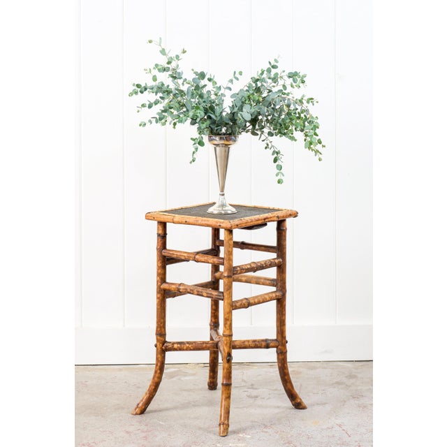 This 19th-century tortoise bamboo side table features gracefully splayed bamboo legs and stretchers. The rich...