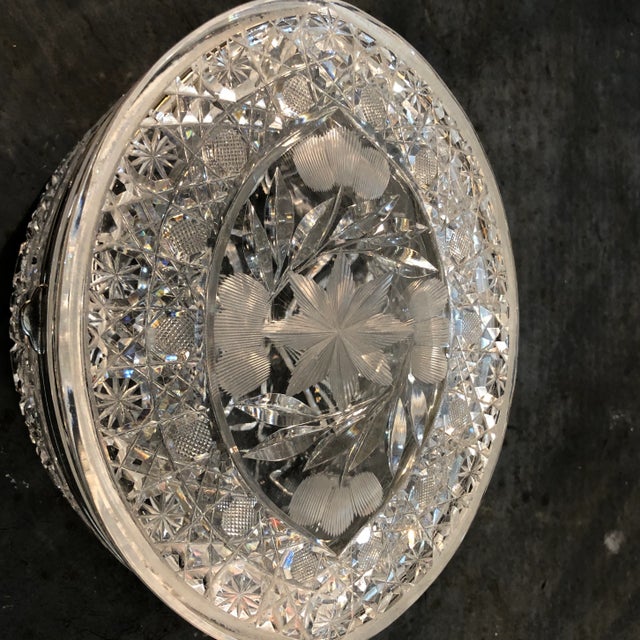 Fine quality Large oval cut crystal box with silver mounts. Bottom is cut back so that box sits raised on glass feet.