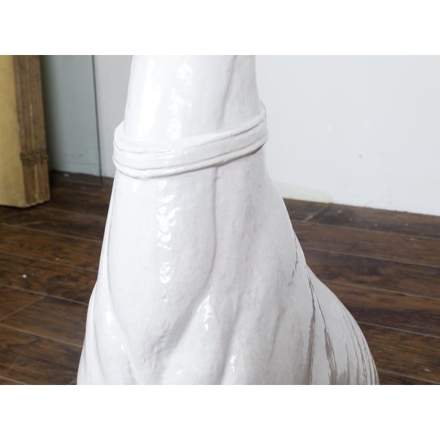A vintage Italian Midcentury white porcelain sculpture depicting a greyhound dog sitting obediently on his behind. Lend an...