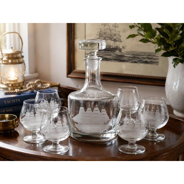 Bring timeless nautical elegance to your home bar with this handsome vintage seven-piece Captain’s decanter set, featuring...