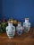 Exquisite set of three vintage Chinese cloisonné vases, hand-enameled with intricate floral and bird motifs over a classic...
