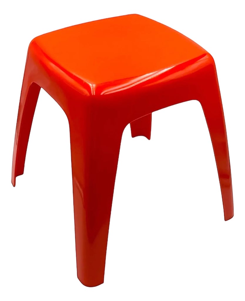 Red molded plastic stool viewed from the side, showing the seat and legs.