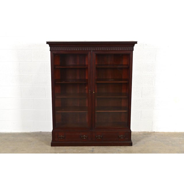 A gorgeous antique Eastlake Victorian bookcase cabinet In the manner of Herter Brothers USA, Circa 1880s Carved mahogany,...