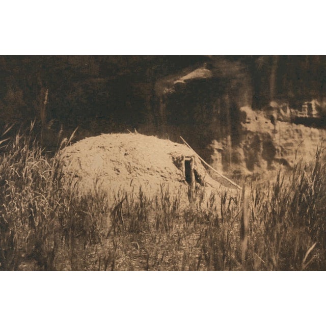 An original photogravure from Edward S. Curtis's The North American Indian. Cañon Hogán shows a Navajo hogan, a domed,...