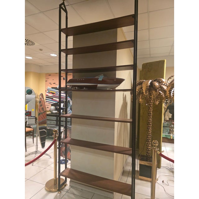 Terra Cielo bookcase or room divider. Scandinavian-style ceiling-mounted shelving unit, 1960s. Lacquered metal uprights...