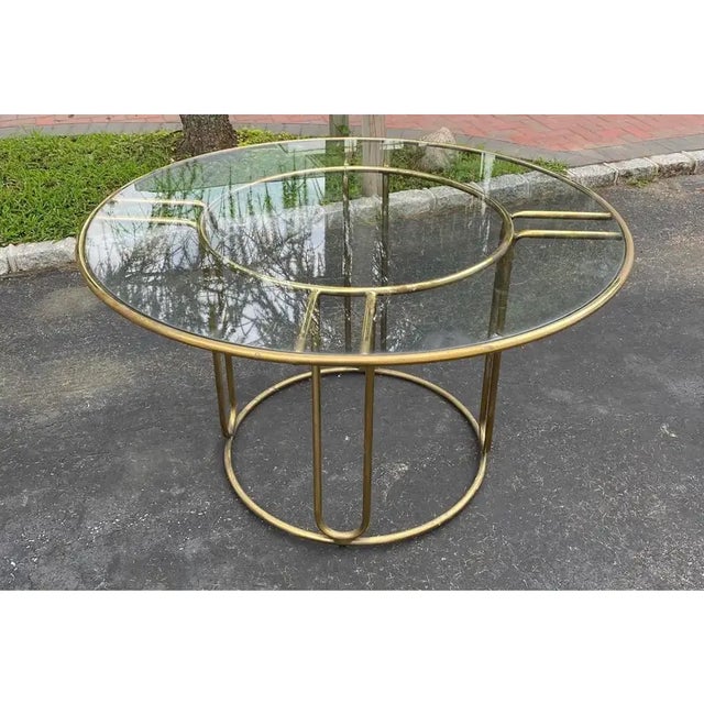 An iconic patio dining set in brass designed by Walter Lamb and produced by Brown Jordan (Set of 5). The round table frame...