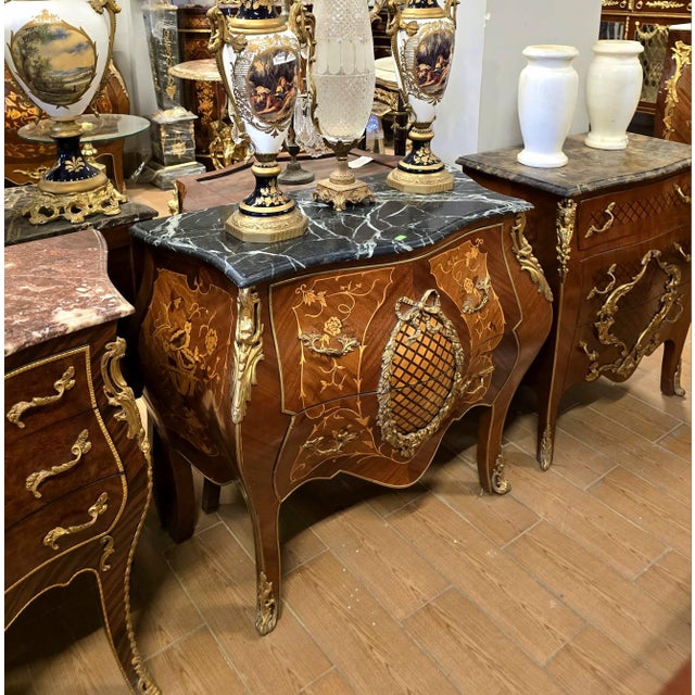 Make a statement with this magnificent French bombe commode, showcasing exceptional floral marquetry, graceful serpentine...