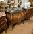 Make a statement with this magnificent French bombe commode, showcasing exceptional floral marquetry, graceful serpentine...