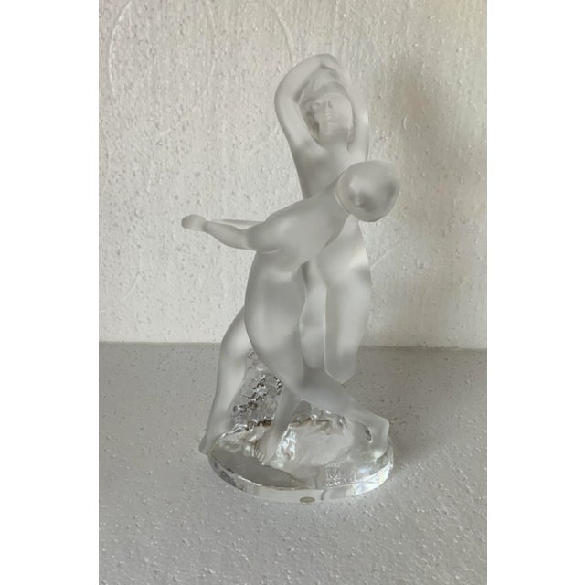 Entwined figures in a graceful dance, elegant, simplicity in the original Lalique box.