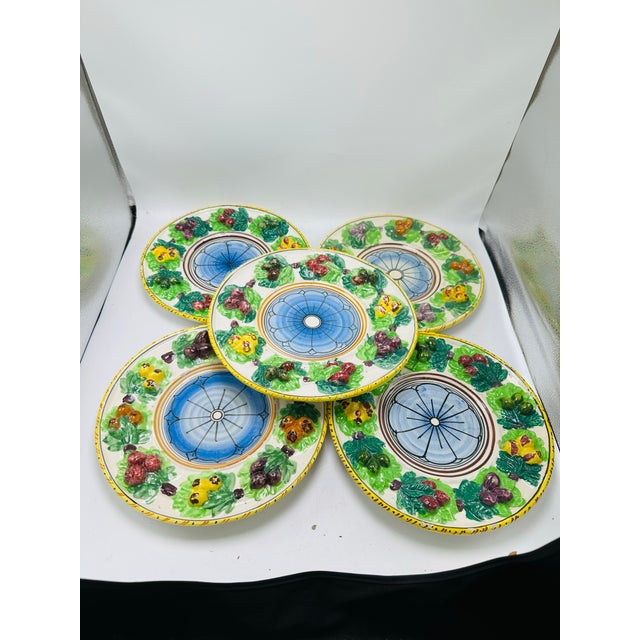 This is a vibrant set of six hand-painted ceramic plates with a rustic, Mediterranean or Italian majolica style. Each...