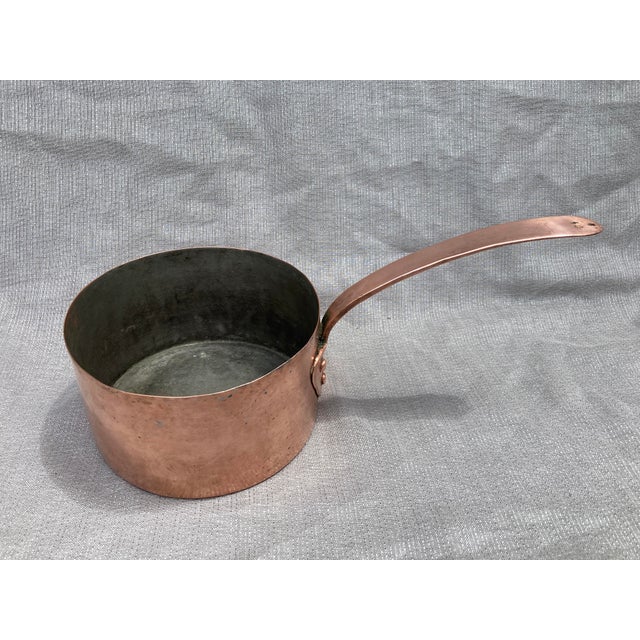Antique polished hand wrought copper and iron saucepan. Stamped #40, no others markings. Saucepan measures 15" long by 7...