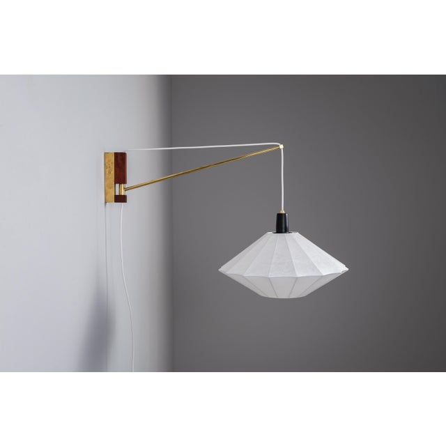 Bring sculptural elegance to your interior with this unique suspension wall lamp, a refined blend of materials and...