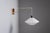 Bring sculptural elegance to your interior with this unique suspension wall lamp, a refined blend of materials and...