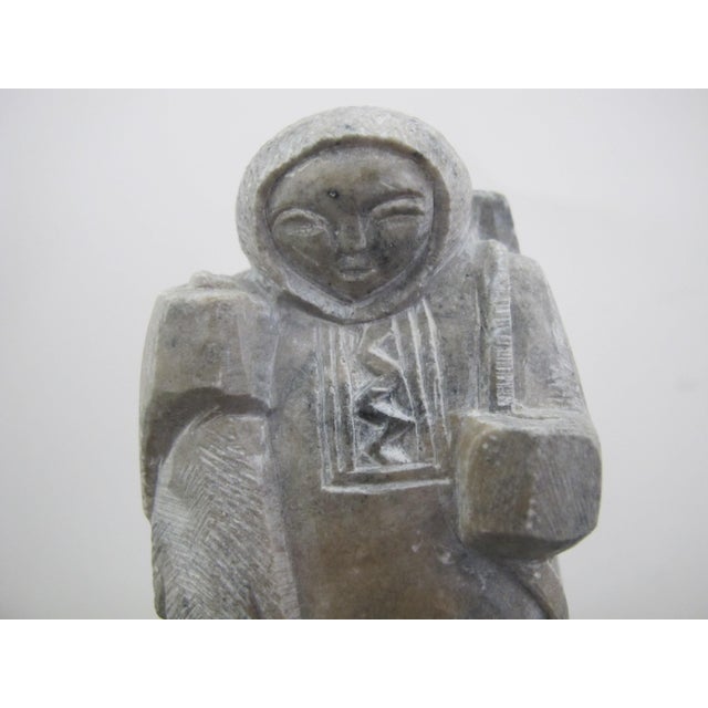 Canadian Inuit small soapstone carving a hunter holding their catch of the day, a beaver with a rifle on their back....