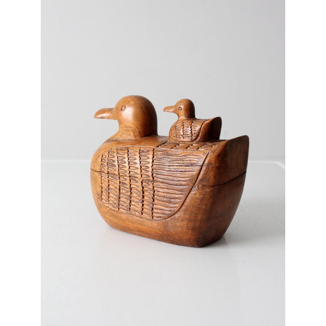 This vintage teak duck box features detailed hand-carved accents and a charming baby duck perched on its back as a handle....
