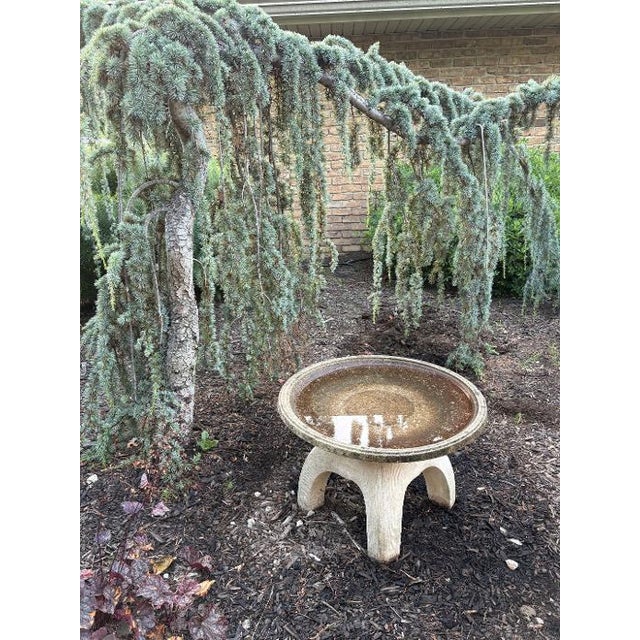 A beautifully proportioned cast‑stone birdbath with a wide, shallow basin resting on a sculptural base. The form is...