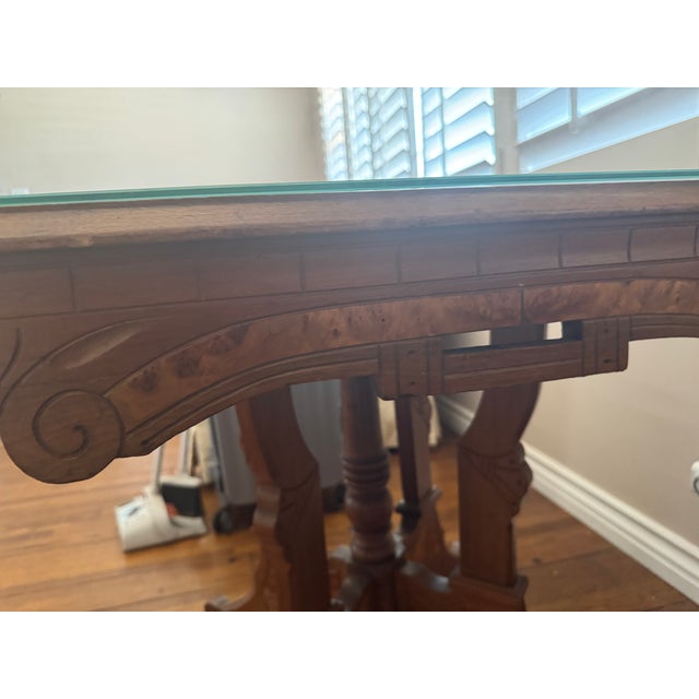 19th century Eastlake parlor table, walnut with burl inlays. In good condition.