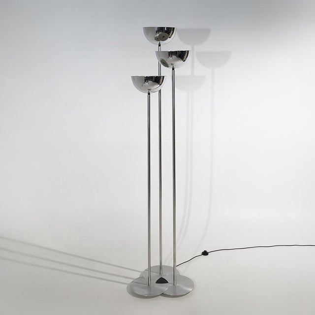 A three-stem floor lamp produced by Lamperti in the 1970s, characterised by a slender vertical composition and three light...