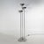 A three-stem floor lamp produced by Lamperti in the 1970s, characterised by a slender vertical composition and three light...