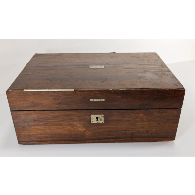 We are selling this nice rosewood veneered writing or stationary box. This box has very attractive exterior but is in need...
