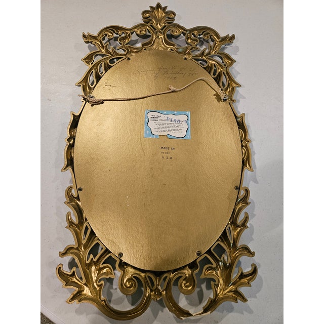 Mid-Century Modern Hollywood Regency oval mirror manufactured in the United States by Turner Mfg. Co., circa 1967. This...
