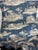 This Williams Sonoma textile is a lovely traditional toile print. The images depict a country scene between two figures.