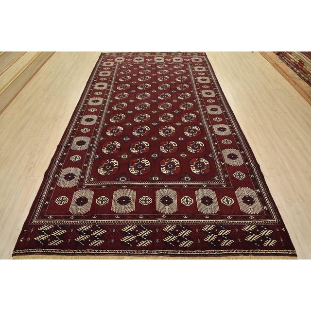 This authentic vintage tribal Turkmen rug is hand-knotted with fine wool and natural dyes. This oriental rug features...