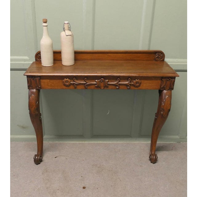 Carved Oak Console or Hall Table This is an attractive piece it stands on carved cabriole legs, the front apron is...