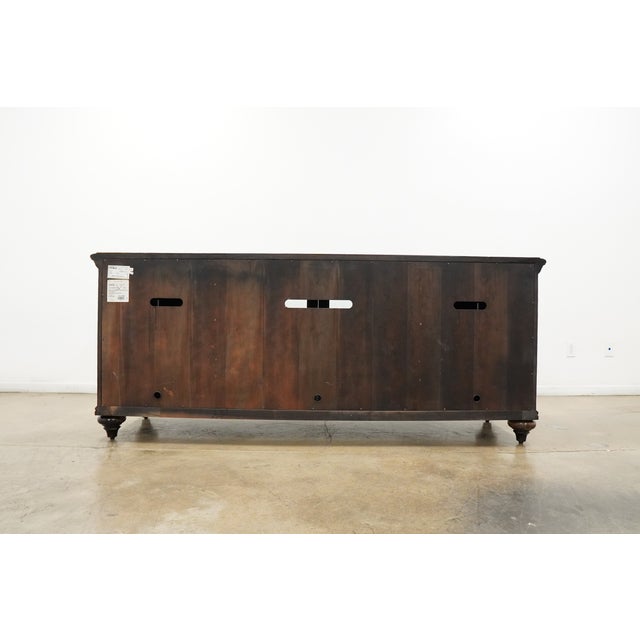 This Tommy Bahama entertainment console from the Wellington collection features a richly finished tamarind wood case with...