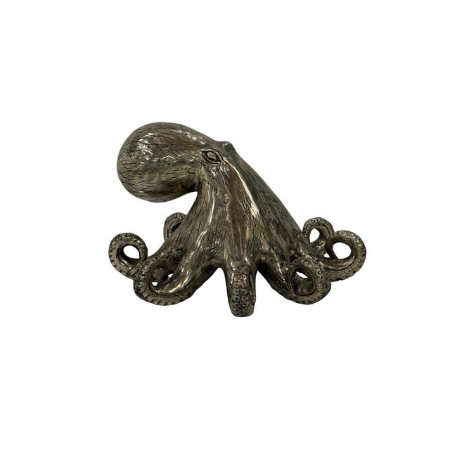 A captivating cast bronze octopus sculpture, embodying the fluid movement and intelligence of this remarkable marine...