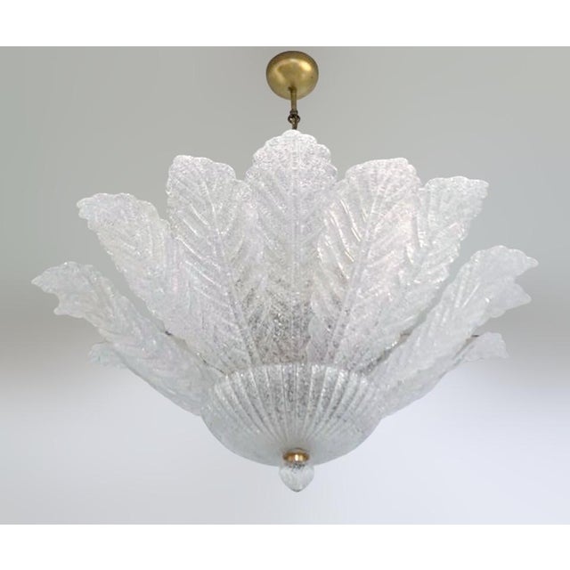 Italian flush mount or chandelier with clear Murano glass leaves hand blown in Graniglia technique to produce a granular...