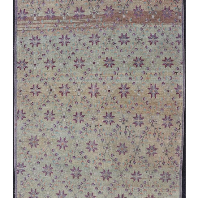 Measures: 4'4 x 9'5 This Turkish Oushak rug features common composition for the region. This piece, heavily inspired by...