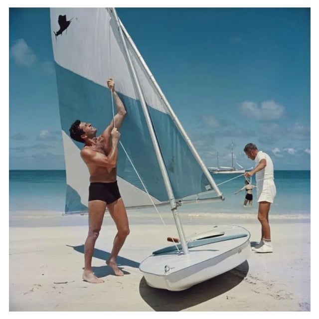 Slim Aarons, Boating in Antigua, Estate Stamped Photographic Print, 1961 / 2020s For Sale
